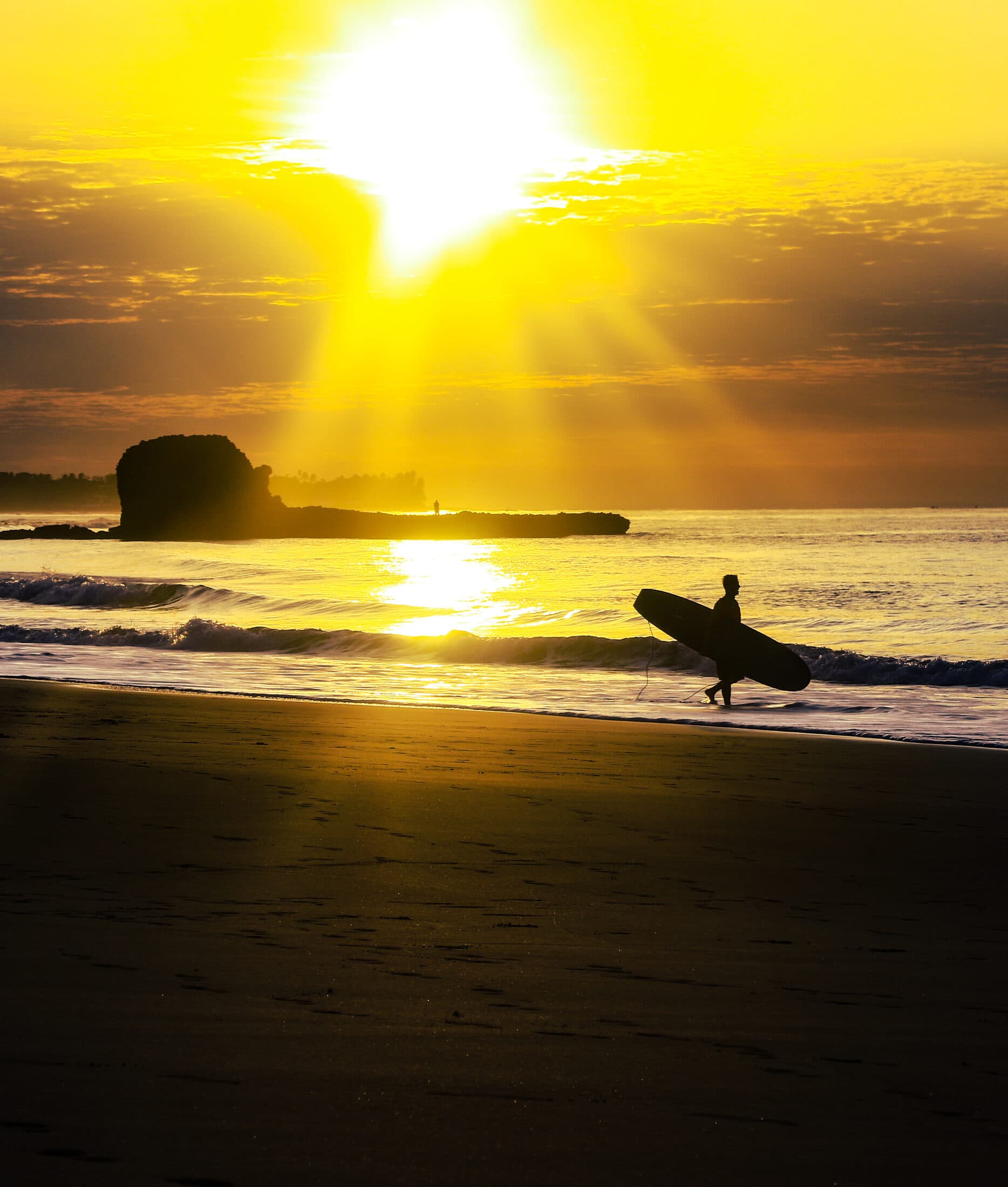 Surfer walking out at golden hour, Surf City